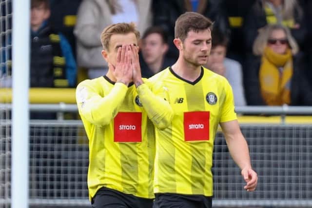 Alex Pattison, left, and Nathan Sheron trudge back to the halfway line after Harrogate Town's defence is breached for a second time during Saturday's 2-1 home defeat to Colchester United. Pictures: Matt Kirkham