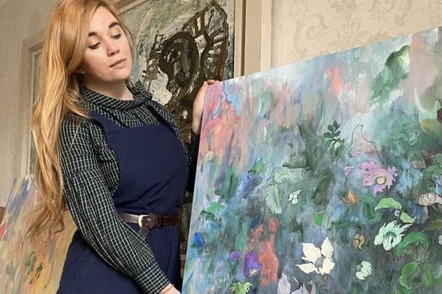 Scarlett Stewart of 108 Fine Art gallery of Harrogate with one of Yukako Sakakura's beautiful canvasses.