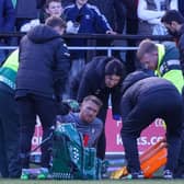 Harrogate Town goalkeeper Mark Oxley receives medical attention before being substituted shortly after Salford City broke the deadlock in Saturday's League Two clash at Moor Lane. Pictures: Matt Kirkham
