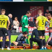 Harrogate Town right-back Ryan Fallowfield receives treatment after injuring his groin during Good Friday's 4-1 home defeat to Swindon. Pictures: Matt Kirkham