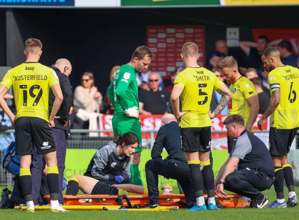 Harrogate Town right-back Ryan Fallowfield receives treatment after injuring his groin during Good Friday's 4-1 home defeat to Swindon. Pictures: Matt Kirkham