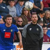 Nathan Sheron takes a throw-in during Harrogate Town's 3-0 defeat at Northampton Town with assistant boss Paul Thirlwell, left, and manager Simon Weaver watching on. Pictures: Matt Kirkham