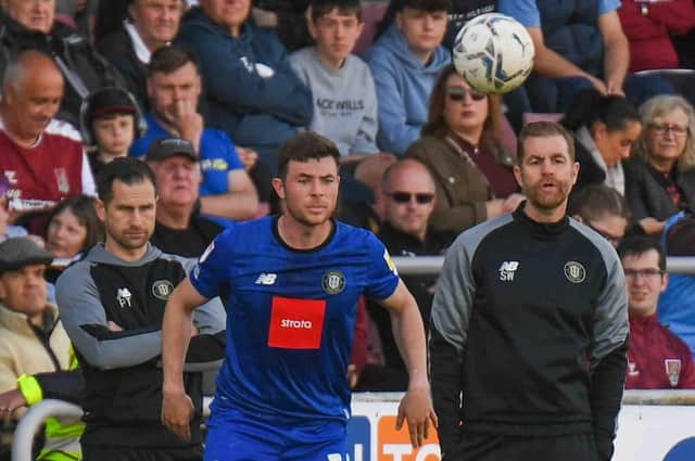 Nathan Sheron takes a throw-in during Harrogate Town's 3-0 defeat at Northampton Town with assistant boss Paul Thirlwell, left, and manager Simon Weaver watching on. Pictures: Matt Kirkham