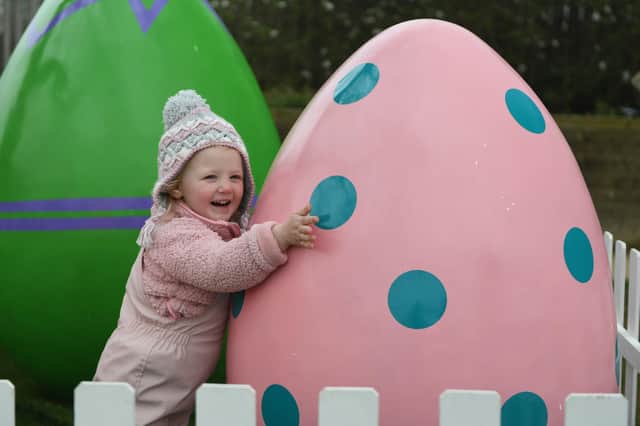 Three-year-old Harriett Stam pictured with a giant egg at RHS Garden Harlow Carr