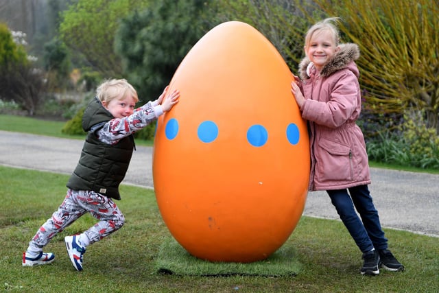Three-year-old Monty Sebo and his sister, six-year-old Alice with one of the giant eggs at the Giant Easter Egg hunt held at RHS Garden Harlow Carr