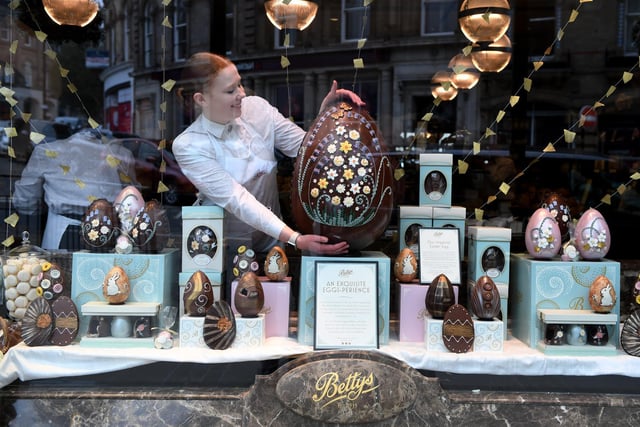 Bettys Shift Leader Lauren Nicholls pictured with the giant egg in the Easter window display