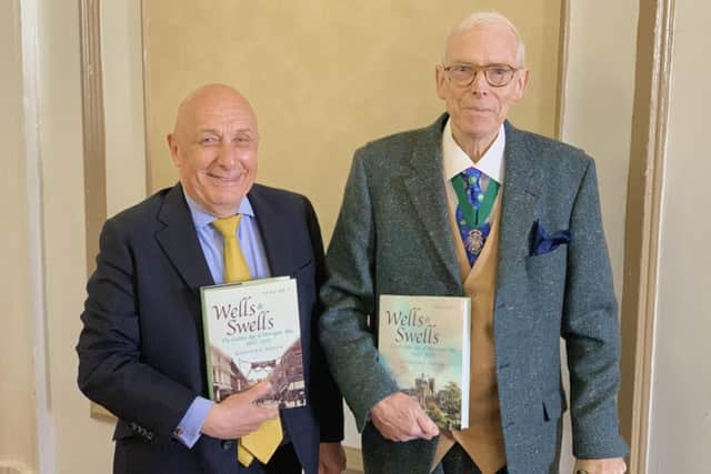 Book signing - Harrogate historian Malcolm Neesam with William Woods during an event this week as part of Woods store's week of anniversary celebrations.
