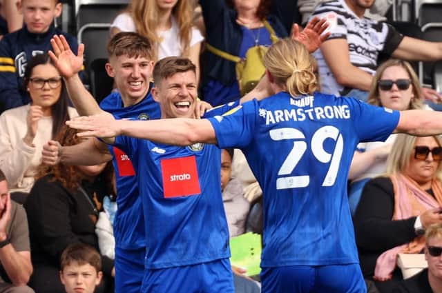 Lloyd Kerry is congratulated by his Harrogate Town team-mates after firing the visitors into a 3-1 lead at Forest Green Rovers. Pictures: Matt Kirkham