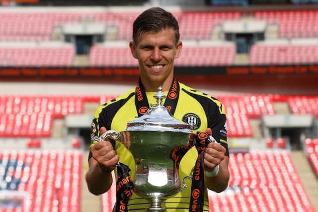 Lloyd Kerry at Wembley Stadium with the 2019/20 National League play-off final winners' trophy.
