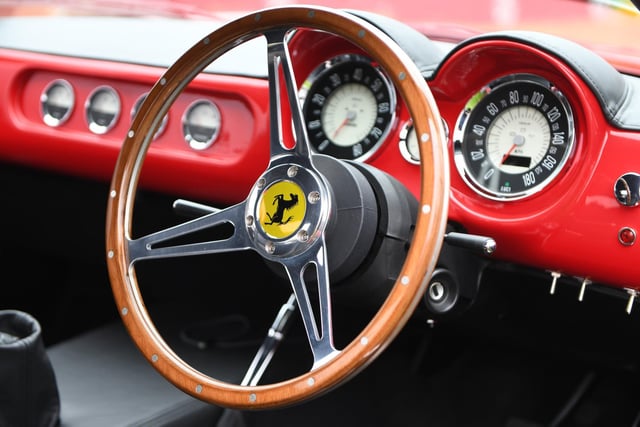 A Ferrari steering wheel in a classic interior