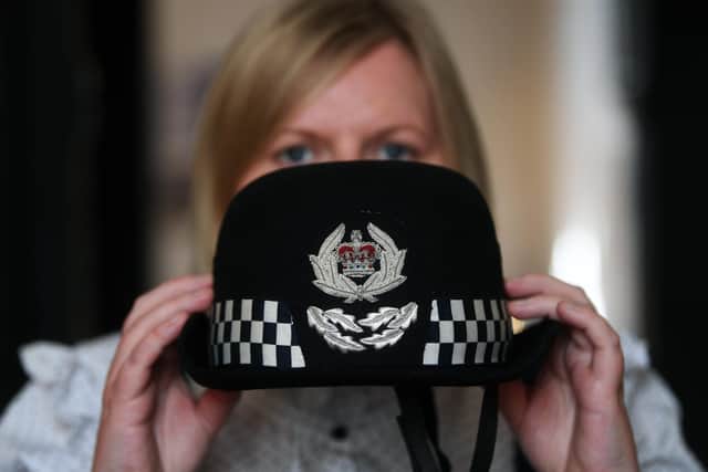 Curator Laura Allan with the North Yorkshire Police Chief Constable's cap, worn by Della Canning, the firts female Chief Constable of the force in 2002, which is part of the Women in Policing exhibition at the  Prison & Police Museum in Ripon.5th May 2022.Picture : Jonathan Gawthorpe