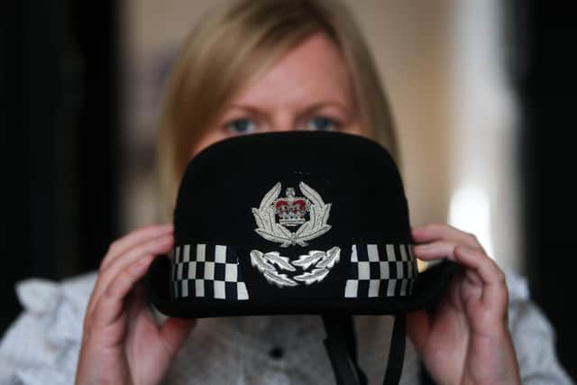 Curator Laura Allan with the North Yorkshire Police Chief Constable's cap, worn by Della Canning, the firts female Chief Constable of the force in 2002, which is part of the Women in Policing exhibition at the  Prison & Police Museum in Ripon.
5th May 2022.
Picture : Jonathan Gawthorpe