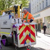 Bethany Allen, Harrogate BID's Business and Marketing Executive, helps the team from Acorn Lighting dress the streets with 4km of royal  bunting.