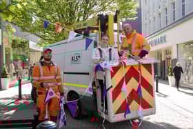 Bethany Allen, Harrogate BID's Business and Marketing Executive, helps the team from Acorn Lighting dress the streets with 4km of royal  bunting.