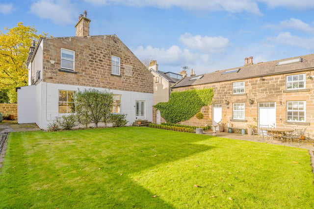 To the rear is a substantial lawned garden with borders to all sides and a beautiful stone wall offering a degree of privacy.