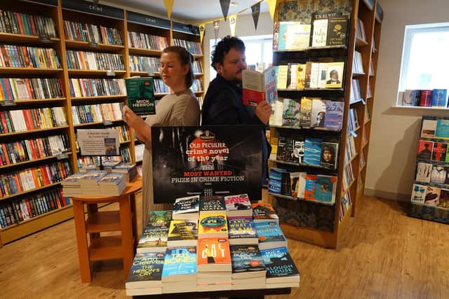 Emma Lloyd, Harrogate International Festivals marketing manager and Keiran Lancaster, Waterstones Harrogate book specialist, with the 18 longlisted titles.