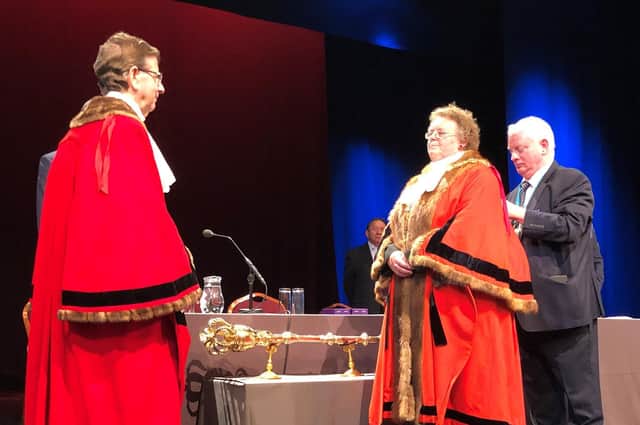 The handing over of the mayoral chains from outgoing mayor councillor Trevor Chapman to new mayor councillor Victoria Oldham. Photo: Harrogate Borough Council.