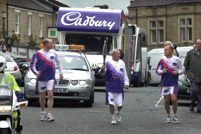 Jack Taylor (centre) carries The Baton for The Queens Jubilee Baton Relay through Wetherby escorted by George Martin (left) and John Fairey.