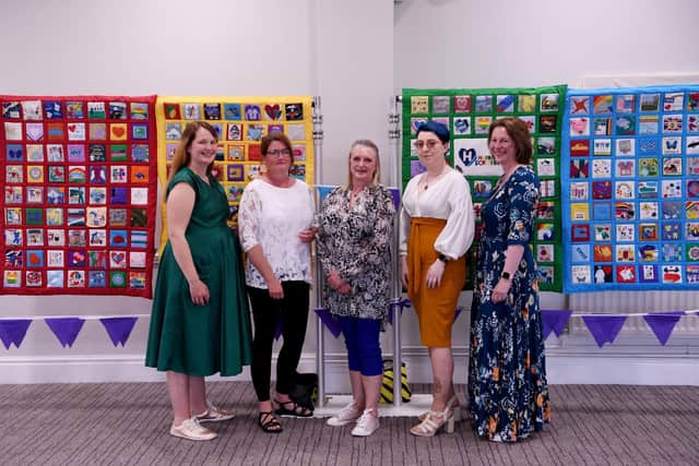 Harrogate Scrubbers celebrations at the Pavilions of Harrogate -  Pictured with the Harrogate Scrubbers quilts are, from left,  Fran Taylor, Claire Strachan, Pam Mullins, Elise Madolyn Johnson, Lisa Sumpton. Picture Gerard Binks