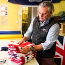 KNARESBOROUGH, ENGLAND - MAY 23: Andy Ormrod, Managing Director at the Flying Colours Flagmakers factory sorts through Union Flags on May 23, 2022 in Knaresborough, England. Preparations are taking place across the country ahead of the Queenâ€TMs platinum jubilee celebrations. (Photo by Ian Forsyth/Getty Images)
