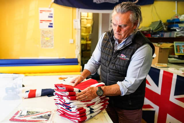 KNARESBOROUGH, ENGLAND - MAY 23: Andy Ormrod, Managing Director at the Flying Colours Flagmakers factory sorts through Union Flags on May 23, 2022 in Knaresborough, England. Preparations are taking place across the country ahead of the Queenâ€TMs platinum jubilee celebrations. (Photo by Ian Forsyth/Getty Images)