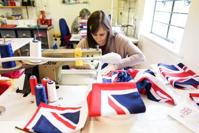 KNARESBOROUGH, ENGLAND - MAY 23: Fiona Baxter makes Union Flags at the Flying Colours Flagmakers factory on May 23, 2022 in Knaresborough, England. Preparations are taking place across the country ahead of the Queenâ€TMs platinum jubilee celebrations. (Photo by Ian Forsyth/Getty Images)