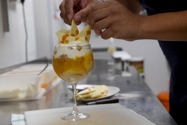 To decorate, top the trifle off with the shards of white chocolate and candied peel, or you can add your own toppings