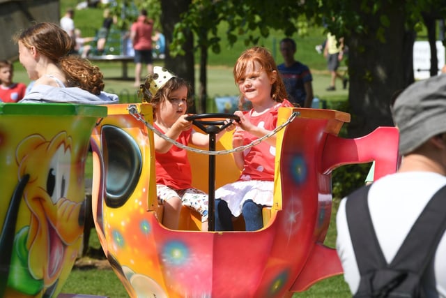 Two youngsters enjoy the fairground rides in Valley Gardens.