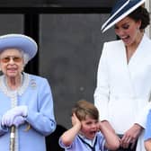 Catherine, Duchess of Cambridge, reacts as Prince Louis of Cambridge covers his ears, as they stand with Queen Elizabeth II and Princess Charlotte of Cambridge to watch a special flypast from the Buckingham Palace balcony.
