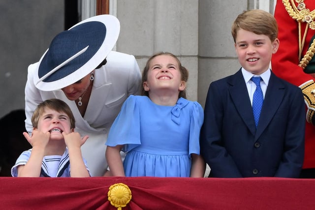 Prince Louis pulls a funny face as sister Princess Charlotte and brother Prince George watch a special flypast from the Buckingham Palace balcony.