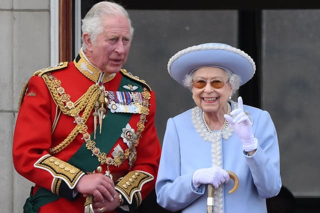 Queen Elizabeth II stands with Prince Charles, Prince of Wales to watch a special flypast from the Buckingham Palace balcony following the Queen's Birthday Parade, the Trooping the Colour, as part of Queen Elizabeth II's platinum jubilee celebrations.