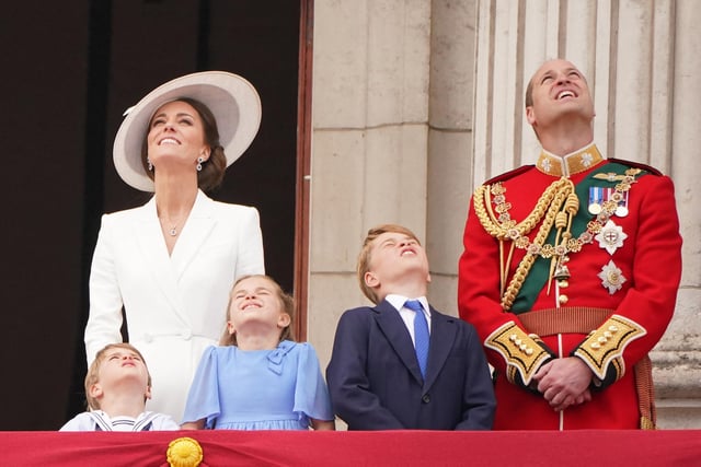 Look up!!! Prince Louis, Catherine, Duchess of Cambridge, Princess Charlotte, Prince George and Prince William, Duke of Cambridge, stand to watch a special flypast from the Buckingham Palace balcony.