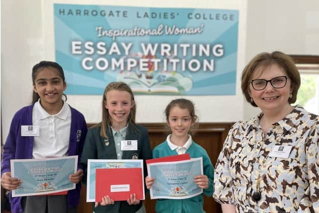 The three winners of the essay writing competition, Arya Bhachu, Samantha Lusted and Sylvie Nicholls with Mrs Sylvia Brett