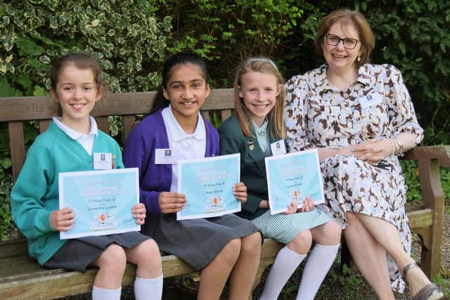The three winners of the essay writing competition, Samantha Lusted, Arya Bhachu and Sylvie Nicholls with Mrs Sylvia Brett