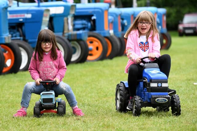 Chloe Tiplady (aged five) and her sister Sophia (aged seven) playing on the toy tractors