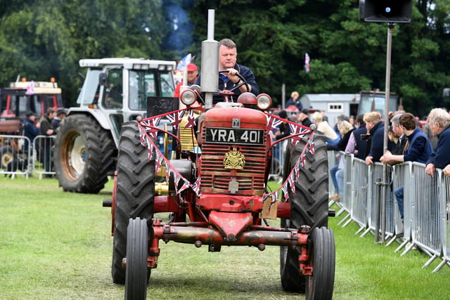 A vintage tractor on parade in the main ring at the show