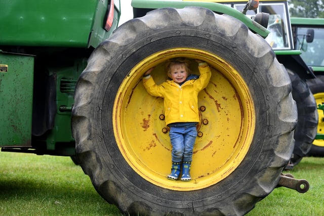 Otto Stubbs (aged two) stood in the wheel of a 8440 John Deere tractor