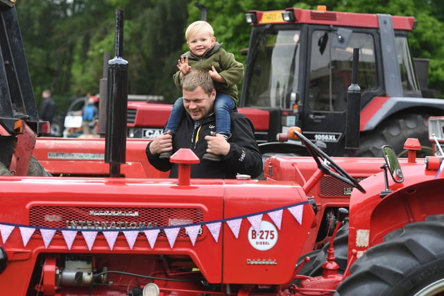 Tommy Summerbell (aged three) and his dad David taking a look at the tractors on display