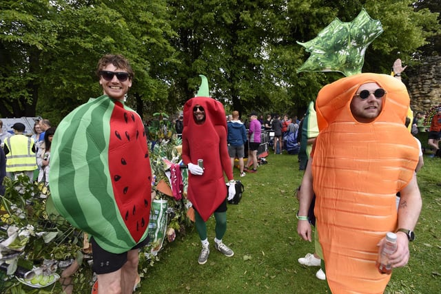 Competitors in fancy dress wait for the result of the best dressed bed contest before the start of the race