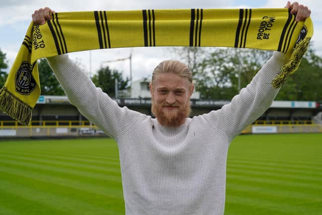 Luke Armstrong has agreed a new long-term contract with Harrogate Town.