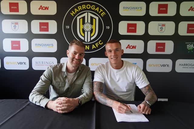 Town boss Simon Weaver with new signing Kyle Ferguson at the EnviroVent Stadium.