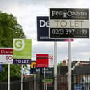 A variety of To Let, Let By and Sold estate agent signs outside houses in Richmond upon Thames, London.