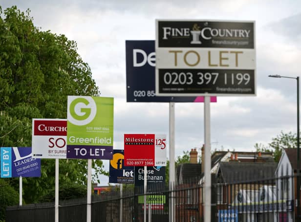 A variety of To Let, Let By and Sold estate agent signs outside houses in Richmond upon Thames, London.