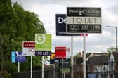 A variety of To Let, Let By and Sold estate agent signs outside houses in Richmond upon Thames, London.