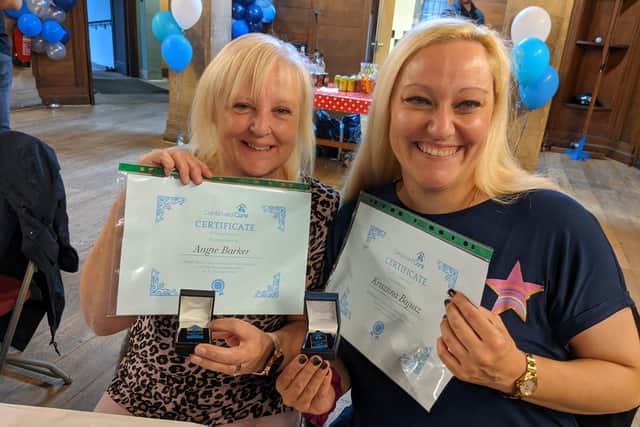 Angie Barker (left) and Krisztina Bajusz (right) with their long service certificates and badges