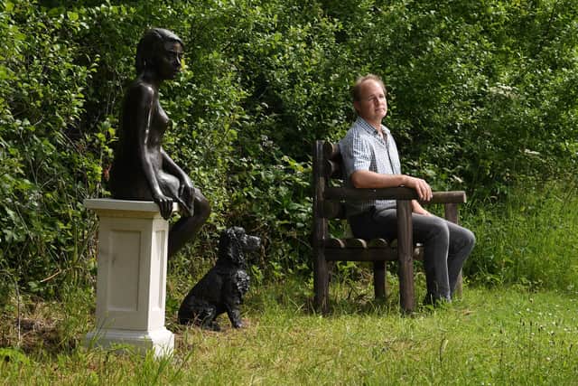 Contemporary Sculpture Trail at Newby Hall, Ripon..Curator Orlando Compton pictured with the Girl in the Polka Dot Dress and Cocker Spaniel by Kate Denton..16th June  2022