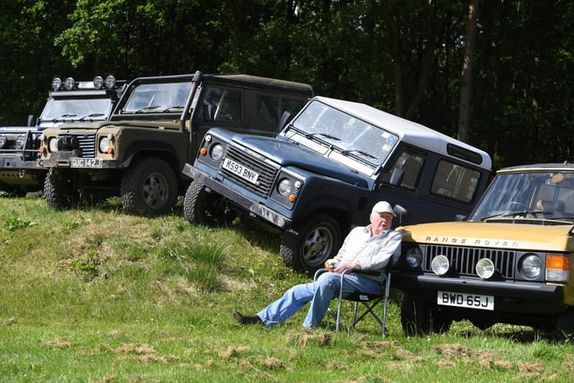 Enjoying the sunshine in front of the Land Rovers on display at the show