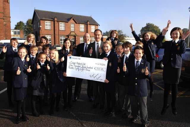 Pupils from Ripon Grammar School raise a whopping £1700.88p for Cancer Research UK, after taking part in a Summer Sponsored Walk. Head teacher Martin Pearman centre right, collects the cheque on behalf of the Charity.