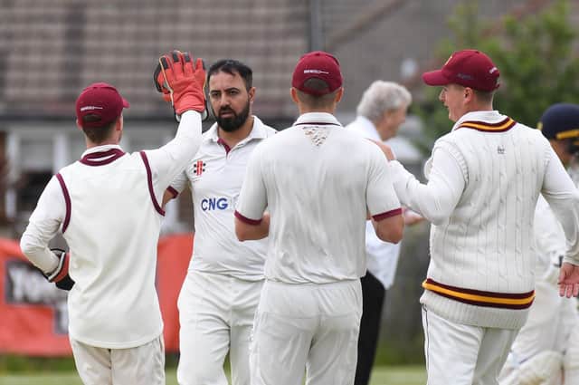 Tuseif Arshad is congratulated by his Bilton CC team-mates after taking a wicket during Saturday's derby success over Beckwithshaw. Pictures: Gerard Binks