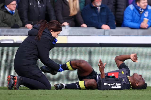 Brahima Diarra receives treatment from Harrogate Town physio Rachel Davis after suffering an ankle injury away at Bristol Rovers in early March.